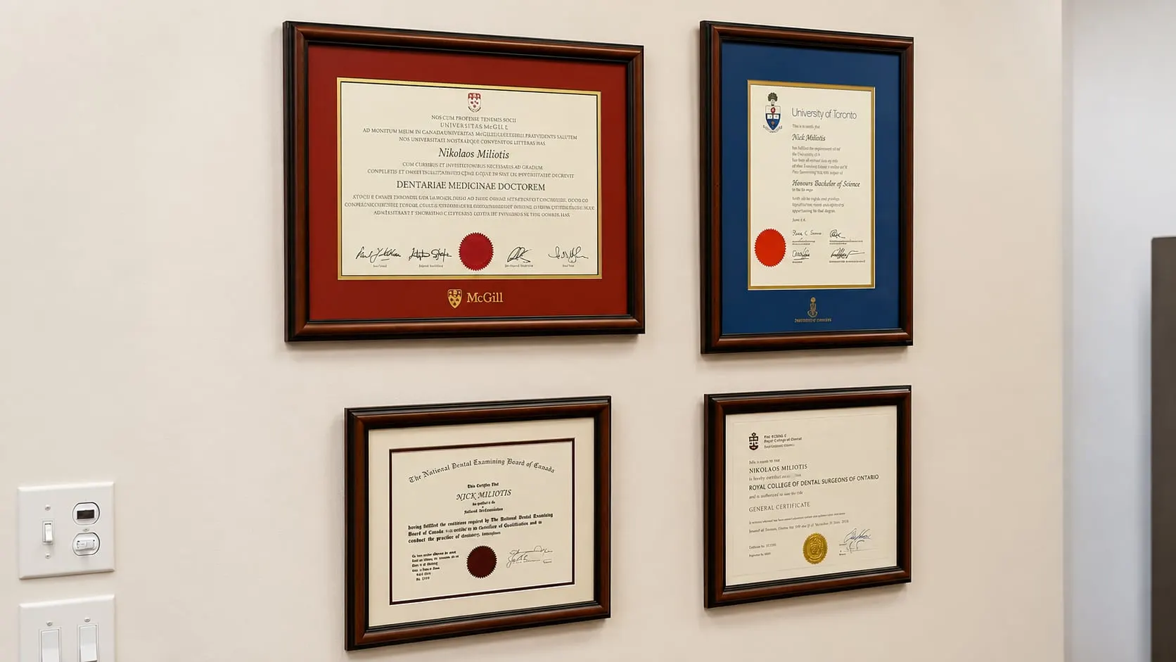 Dr. Nick Miliotis's framed dental degrees and certificates