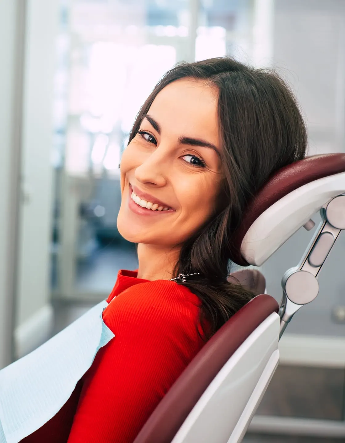A smiling woman relaxing in a dental chair